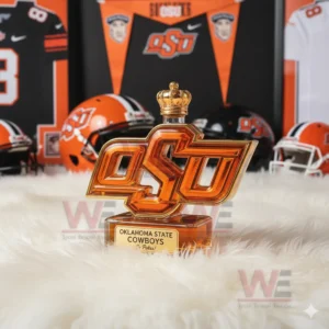 An orange OSU bottle with a crown cap sits on a white rug surrounded by Oklahoma State football decor!