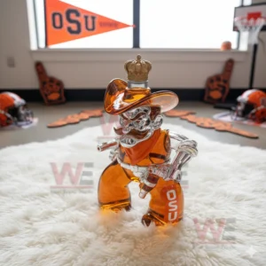 OSU Oklahoma State Cowboys Whiskey Bottle 11 A cowboy shaped orange filled bottle sits on a white rug with OSU helmets and banners behind it!