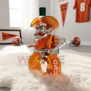 OSU Oklahoma State Cowboys Whiskey Bottle 12 A cowboy shaped bottle filled with orange liquid stands on a white rug with OSU helmets and banners behind it!