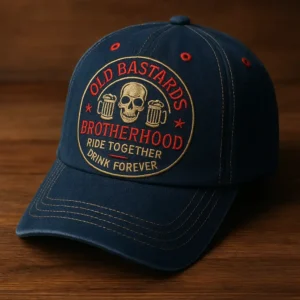 Navy cap with skull and beer logo embroidered in red and gold on wood table.