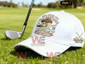 White Old Bastards Golf Club cap on golf course grass next to a golf club.