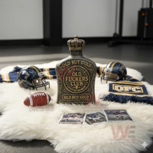 A gold accented bottle sits on a white rug with helmets a football a scarf and sports cards nearby!