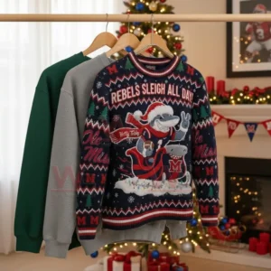 Three sweaters, including one with a shark mascot, displayed on hangers in front of Christmas decorations.