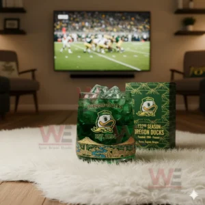 Green Oregon Ducks drink glass on white rug with football game on television!