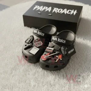 Black Papa Roach Crocs with rock music themed charms displayed before a black box on a light surface!