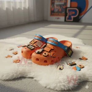 Orange Paramore Crocs with colorful charms displayed on a white rug in bright sunlight!