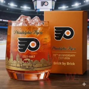 Philadelphia Flyers 59th Anniversary Whiskey Glass 3 A Philadelphia Flyers anniversary whiskey glass with ice next to a branded gift box in a stadium environment.