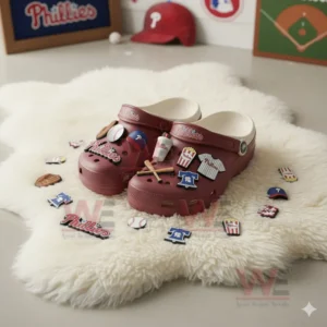 Red Phillies clogs with assorted charms surrounded by scattered baseball themed pieces on white fur.