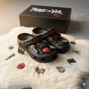 Black Pierce The Veil Crocs with musical charms and logo box on white rug.