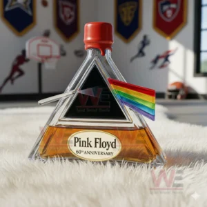 A red capped Pink Floyd prism bottle sits on a white rug with sports decor behind it!