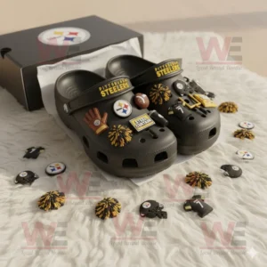 Pittsburgh Steelers Crocs with themed charms beside a team box on a white rug!