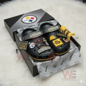 Black Steelers clogs with assorted yellow and black charms inside an open Steelers box.