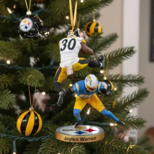 Pittsburgh Steelers Jaylen Warren Christmas ornament showing the player jumping over a defender with team decorations on the tree.