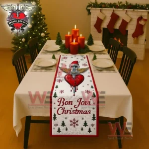 A festive table runner with a winged heart and sword design and holiday text placed on a decorated dining table!