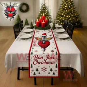 A Christmas table runner with a winged heart and sword motif placed on a decorated dining table in a festive room!```