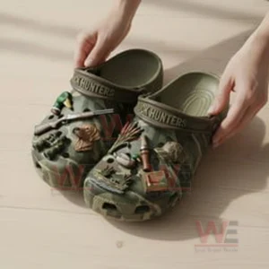 Premium Duck Hunters Crocs Crocband Clogs With Charms 3 Hands lifting camo clogs decorated with duck hunting themed charms.