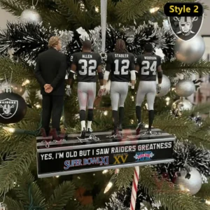 A Christmas ornament featuring three Raiders legends and a coach positioned on a decorated stand with festive tree ornaments behind them!