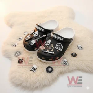 Black Ramones charm decorated clogs displayed on a white rug!