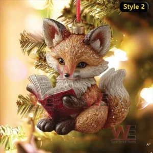 Fox Christmas ornament reading a red book hanging on tree with golden background lights!