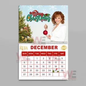 Reba McEntire 2026 Wall Calendar 17 December page with Reba McEntire holding a Christmas ornament by a tree.