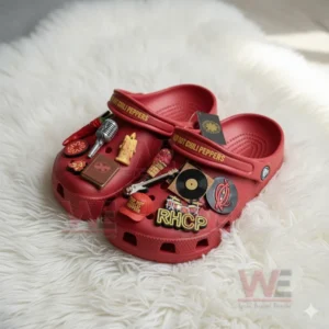 Red Hot Chili Peppers Crocs Clogs with Charms 6 A detailed shot of red Red Hot Chili Peppers clogs with band-themed decorations placed on a white rug.