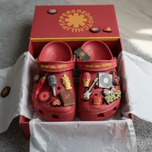 Red Hot Chili Peppers Crocs Clogs with Charms 7 Red Red Hot Chili Peppers clogs decorated with musical and chili motifs are placed inside a matching logo box.
