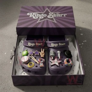 Purple Ringo Starr clogs in an open box with multiple music themed charms.