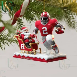 Rutgers Scarlet Knights Christmas ornament featuring a football player pulling Santa's sleigh with festive details and decorations!