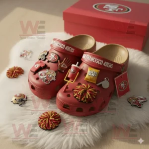 San Francisco 49ers Crocs with scattered charms beside a team box on a white rug!