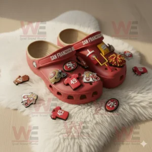 San Francisco 49ers Crocs with themed charms on a white furry rug!