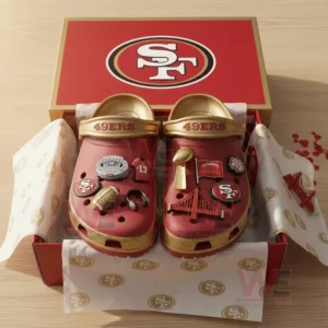 Detailed view of red and gold 49ers Crocs with football themed charms inside box!
