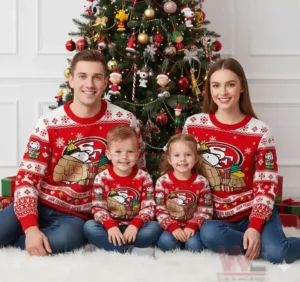 Family wearing matching San Francisco 49ers-themed sweaters with Snoopy by a Christmas tree.