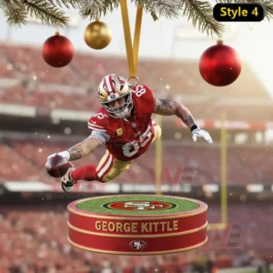 Alt text: George Kittle diving for the football on a Christmas ornament, surrounded by festive decorations and a stadium backdrop.