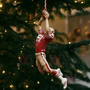 Ornament of a football player jumping to catch a ball hanging on a Christmas tree.
