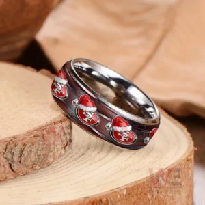 Silver ring on wood showing dark red band with repeating festive emblems in red hats!