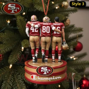 A Christmas ornament displaying three 49ers legends arm in arm on a themed round base with holiday decorations in the background!