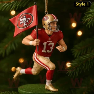 A San Francisco 49ers football ornament of a player in motion holding a red flag decorated on a Christmas tree with lights and pine branches!