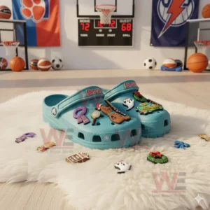 Blue clogs with Scooby Doo decorations featuring cartoon elements like the Mystery Machine and ghost placed on a soft rug in a basketball-themed room.