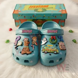 Scooby Doo Mystey Machine Crocs Clogs with Charms 6 Blue Scooby Doo Christmas edition clogs decorated with character charms are displayed in front of a colorful gift box.
