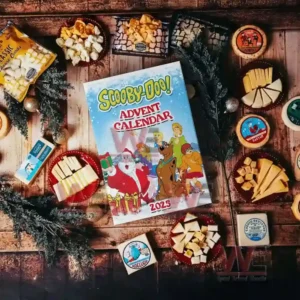 Scooby Doo x Christmas Advent Calendar 5 Alt text: A Scooby-Doo Advent Calendar surrounded by holiday snacks and treats, perfect for a festive celebration.