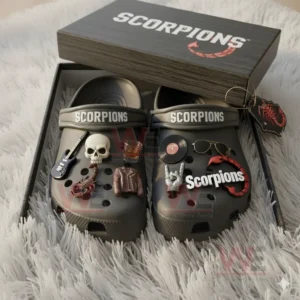 Gray Scorpions clogs decorated with themed charms are displayed inside a black branded gift box.