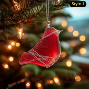 Red glass bird ornament with silver wire wrapping hanging on a Christmas tree with warm lights!