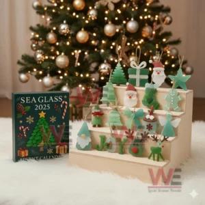 An image of a Sea Glass 2025 advent calendar featuring sea glass Christmas ornaments arranged beside a decorated Christmas tree!