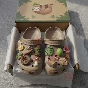 Close-up view of sloth-themed Crocs with charms in a gift box, surrounded by natural decorations.