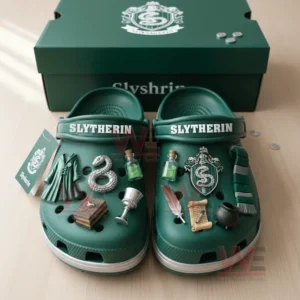 Slytherin Premium Crocs Crocband Clogs With Charms 5 Green clogs with themed charms arranged inside an open green box on a wooden table.