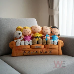 Snoopy Irregularly Shaped Flannel Pillow 3 A plush pillow shaped like Snoopy and friends placed on an orange couch seat on a gray sofa! ``