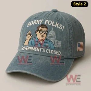 Blue cap with waving man and text Sorry Folks Government’s Closed with flag detail.