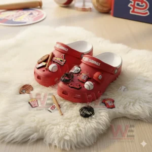 Red St Louis Cardinals Crocs with baseball charms placed on white furry surface!