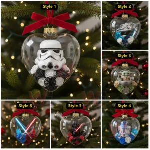 Heart shaped ornaments containing stylized Star Wars characters and themed decorations hanging on a Christmas tree!