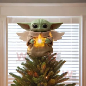 Star Wars Yoda Christmas Tree Topper with Ornament 14 Alt text: Close-up of Baby Yoda tree topper with a glowing star in his hands.